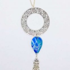 Ring pendant with turquoise blue drop and tassel.
