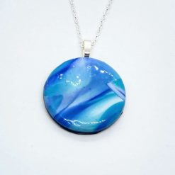 Hand made round Polymer clay pendant in shades of blue and turquoise