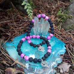 A purple mottled and lava bead bracelet with heart charm