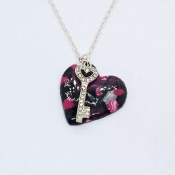 The key to my heart. handmade polymer clay heart pendant on black, pink and silver