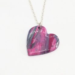 handmade polymer clay heart pendant in marbled pinks and purples