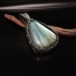 Pale green aqua blue labradorite pendant.Wrapped in antiqued silver metal.