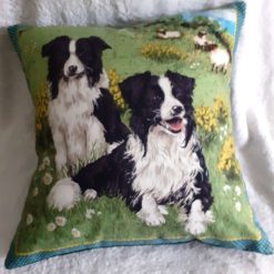 Border Collie sheepdogs in a field with sheep cushion pillow