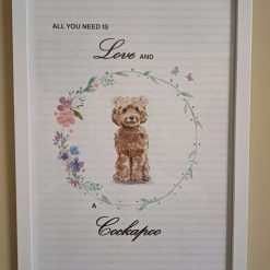 Cockapoo Print, Dog Wall Art, Brown Cockapoo wearing two clusters of pink flowers in her hair standing in a circle of flowers, Home Decor, Dog Lover Framed Print