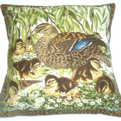 Mallard duck with eight fluffy golden ducklings by the river edge cushion pillow