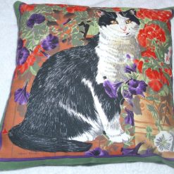 A lovely black and white cat in the garden cushion pillow