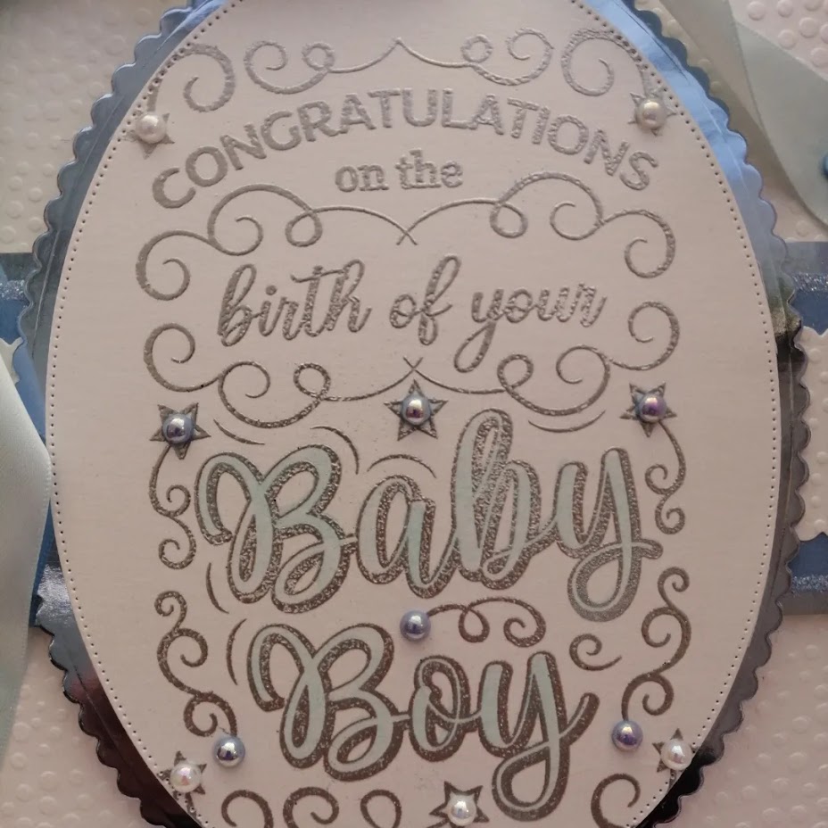 Luxury Handmade New Baby - Congratulations on the birth of your Baby Boy - Oval sentiment to centre with embossed background and pretty pale blue bow & ribbon Luxury Handmade New Baby - Congratulations on the birth of your Baby Boy - Oval sentiment to centre with embossed background and pretty pale blue bow & ribbon