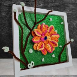 photo frame decorated with crocheted orange flower
