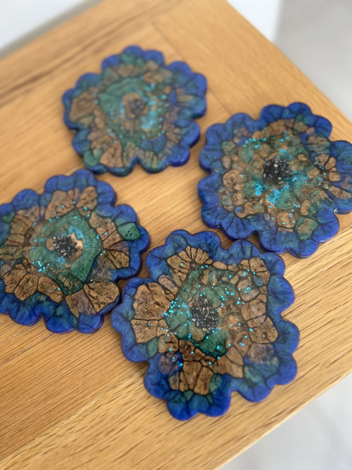 4 resin coasters created through a mix of mica powders and resin MadeMe