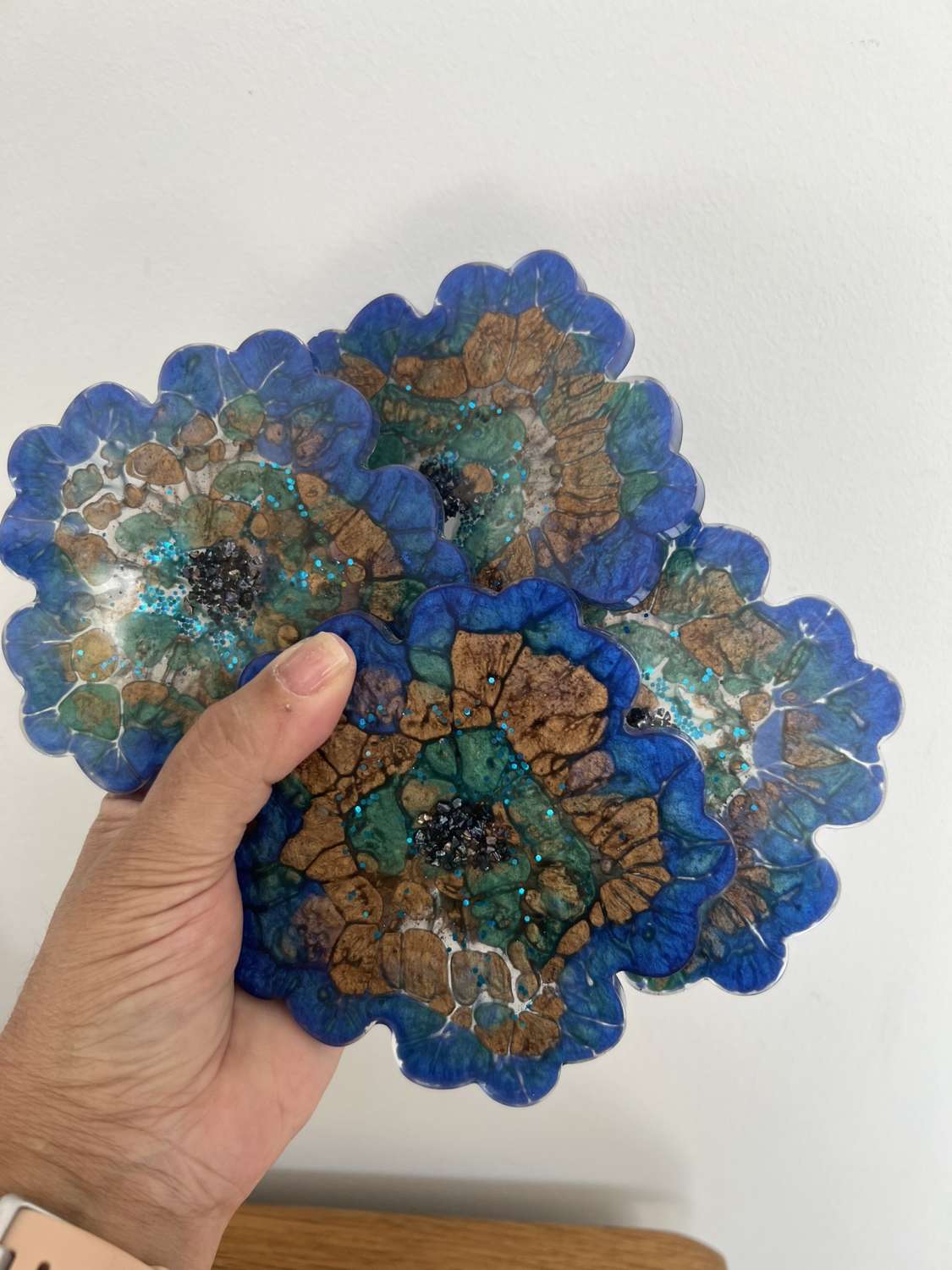 4 resin coasters created through a mix of mica powders and resin MadeMe