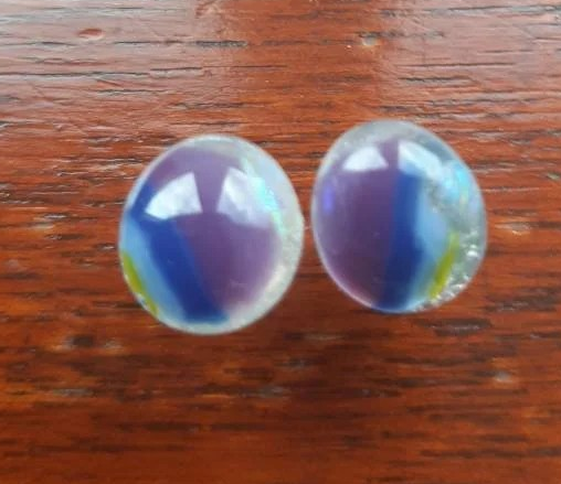 One of a kind, purple, blue, green and clear dichroic rainbow glass studs. One of a kind, purple, blue, green and clear dichroic rainbow glass studs.