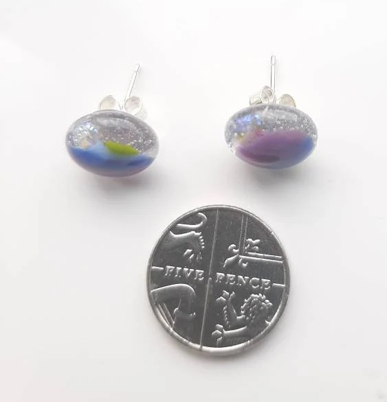 One of a kind, purple, blue, green and clear dichroic rainbow glass studs. One of a kind, purple, blue, green and clear dichroic rainbow glass studs.
