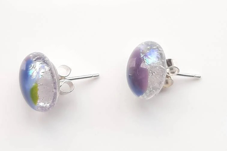One of a kind, purple, blue, green and clear dichroic rainbow glass studs. One of a kind, purple, blue, green and clear dichroic rainbow glass studs.