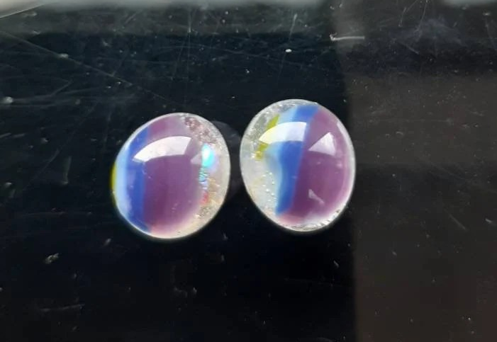 One of a kind, purple, blue, green and clear dichroic rainbow glass studs. One of a kind, purple, blue, green and clear dichroic rainbow glass studs.