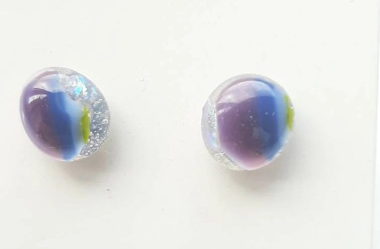 One of a kind, purple, blue, green and clear dichroic rainbow glass studs. One of a kind, purple, blue, green and clear dichroic rainbow glass studs.
