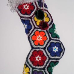 Sparkly Rainbow Coloured Crochet Christmas Stocking, with tinsel yarn cuff as well as embellishments of pompoms and bells.