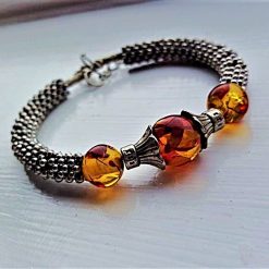 Silver metal beaded bracelet, memory wire bracelet, orange and red fleck stone glass beads, star spacer beads