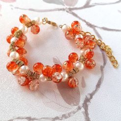 White pearl and orange crackle bead memory wire cluster bracelet