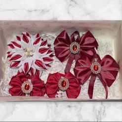 Gift box with hairbows collection in red colors.