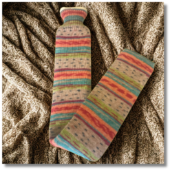 Extra long hot water bottle with handcrafted knitted cover - yarn design Clematis