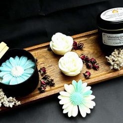 Flower candle  in a tin