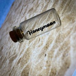 Small glass bottle with cork top for sand ‘honeymoon’ on the bottle