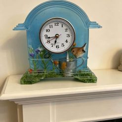 Beautiful clock with bird perched on a watering can
