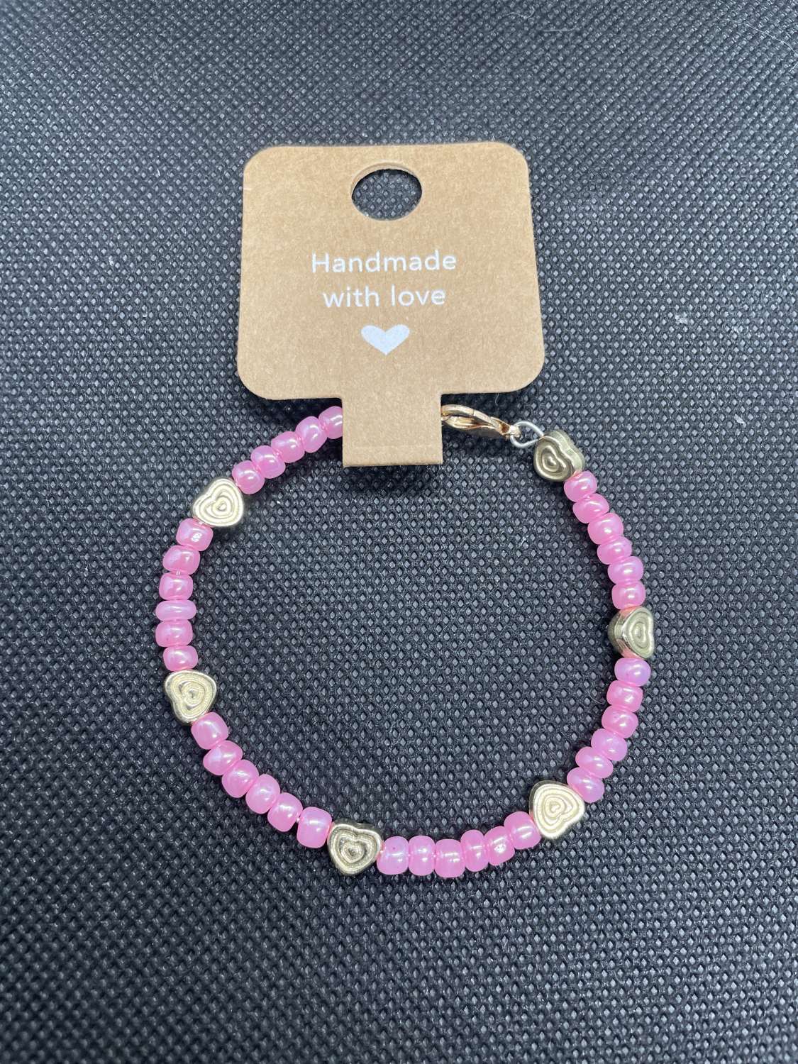 Handmade pink wired bracelet with gold heart charms Handmade pink wired bracelet with gold heart charms