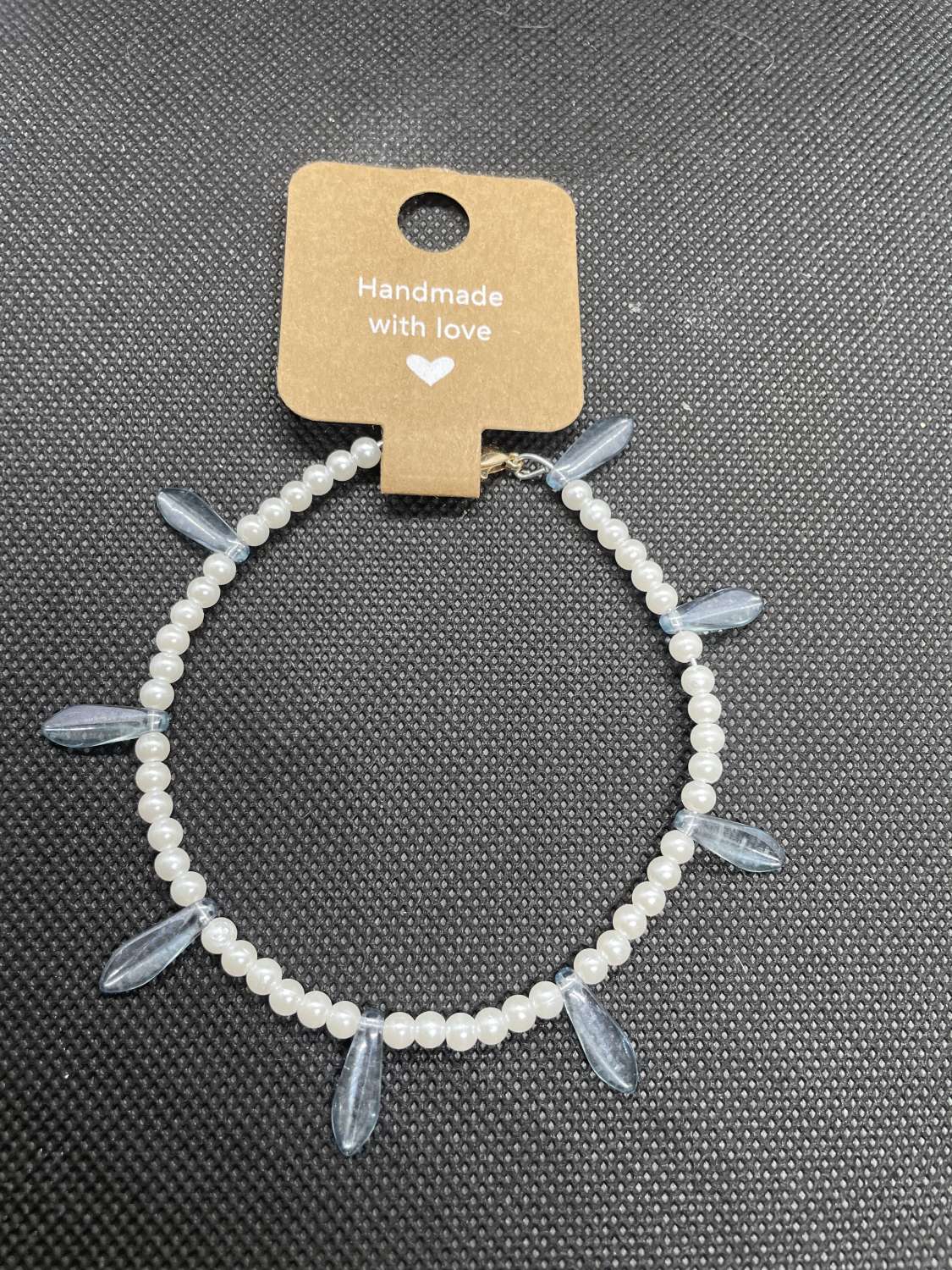Handmade white wired bracelet with blue charms Handmade white wired bracelet with blue charms
