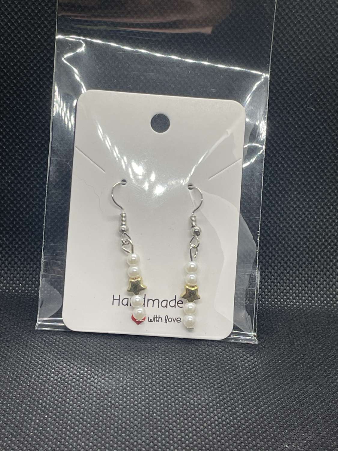 Handmade white beaded and star charmed earrings Handmade white beaded and star charmed earrings