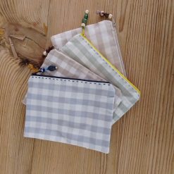 make up bag handmade in check fabric with zipper closure and bead tag.