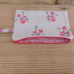make up bag handmade in a floral fabric with handle and zipper closure.