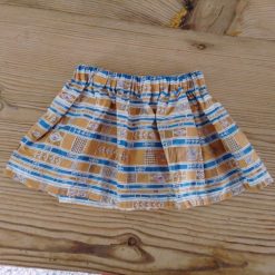 Baby skirt made using mustard yellow fabric with an abstract pattern for 6-9 months.