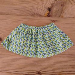 Baby skirt made using mustard yellow fabric with an abstract pattern for 6-9 months.