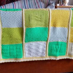 Hand knitted baby blanket in yellow and green colourway