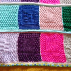 Handmade knitted baby blanket in multi coloured colourway