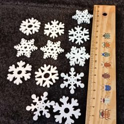 24 pcs. Wooden painted snowflakes in white, green and red